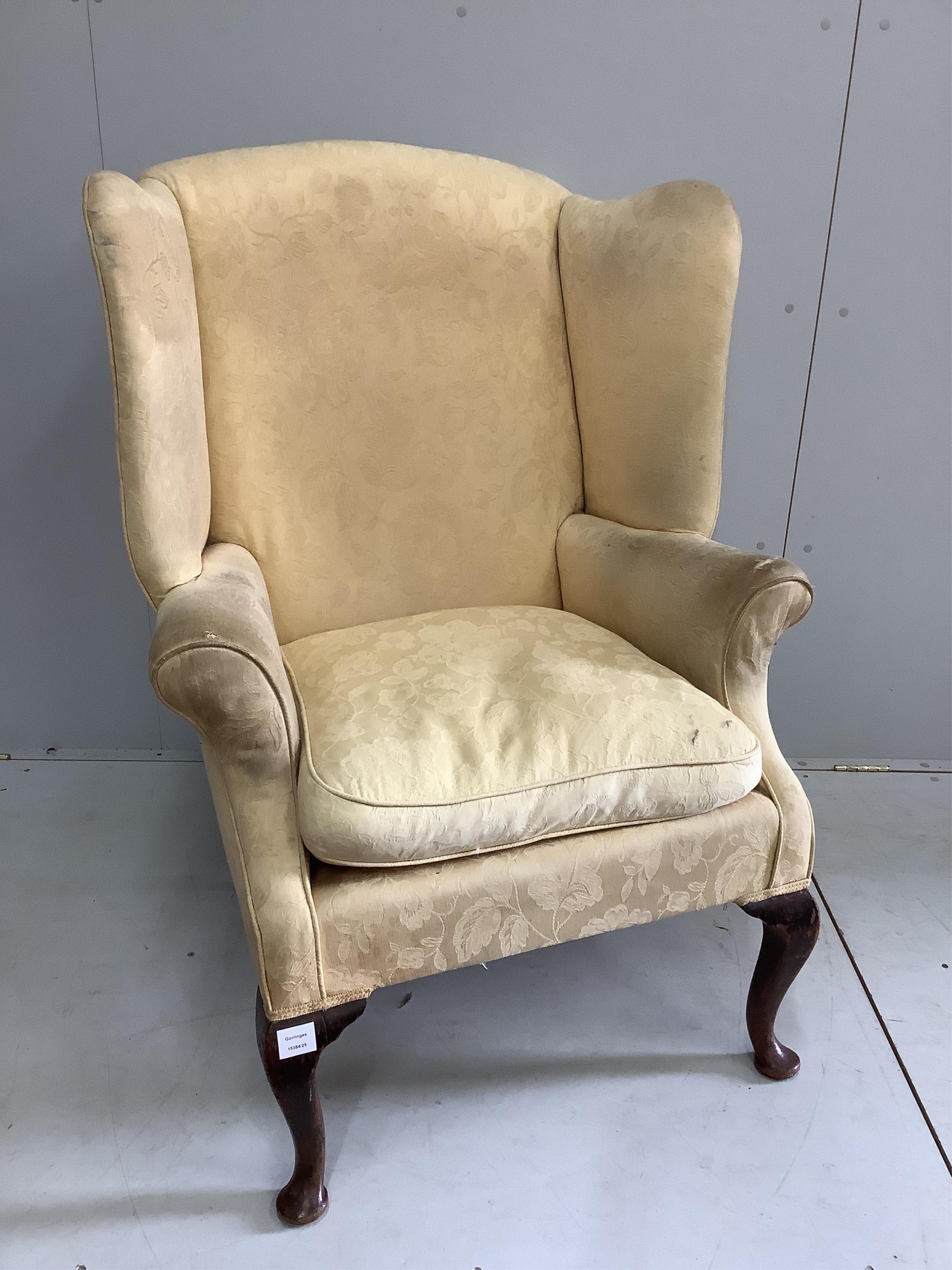 A George III upholstered wing armchair, width 86cm, depth 74cm, height 105cm. Condition - poor to fair